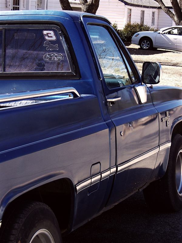 A blue pickup truck parked on a Texas street