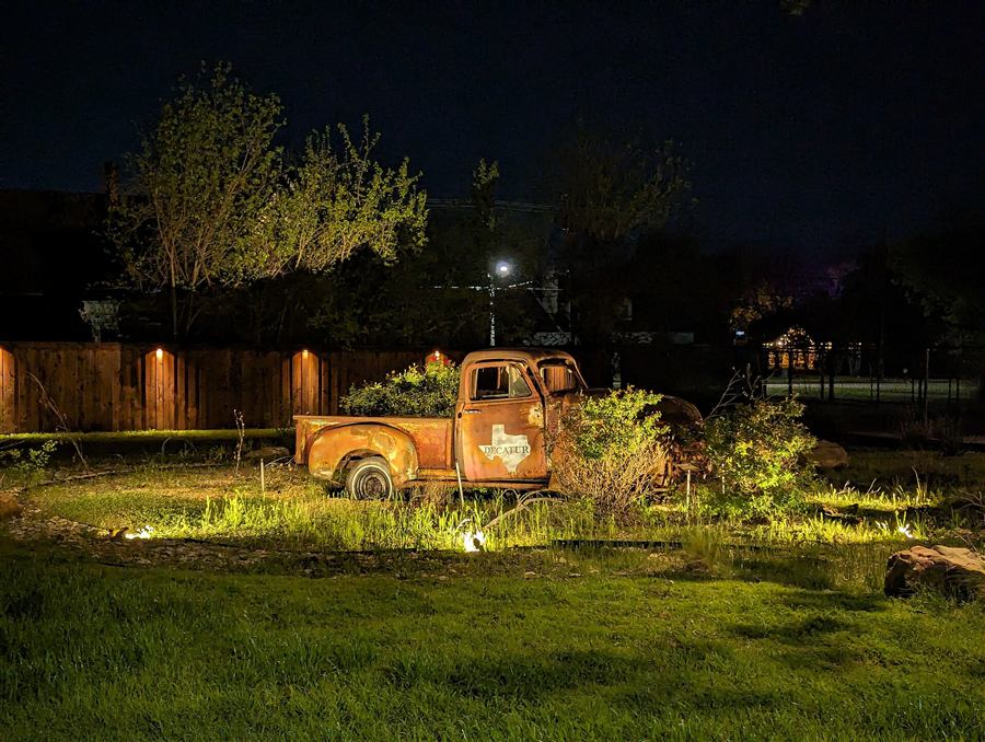 An old Texas pickup truck lit up at night